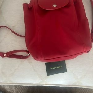 Never used red leather mid size Longchamp backpack with original certification